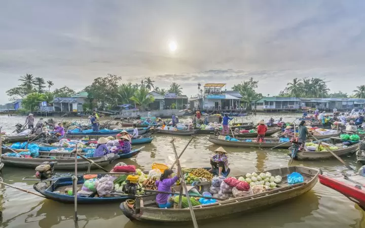A lot of boats and sampans with diverse products gathering and trading on Cai Be floating market A lot of boats and sampans with diverse products gathering and trading on Cai Be floating market