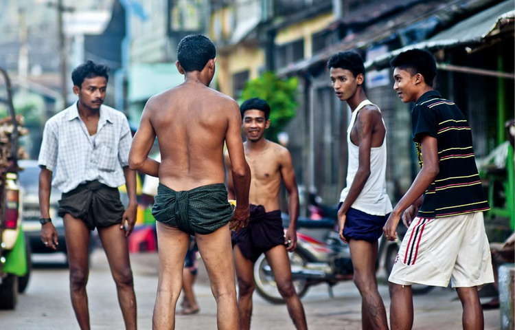 Men playing kick volleyball wearing Longyi